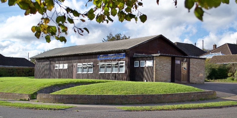 A view of Bishopdown Evangelical Church in Salisbury, featuring a grassy area in front of the building.